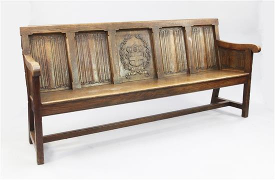 An Edwardian carved oak bench seat, formerly from Christs Hospital, Sussex, W.7ft